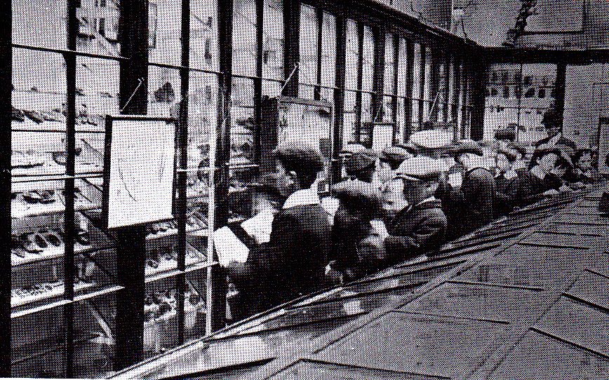 A black and white picture showing school children in the museum.