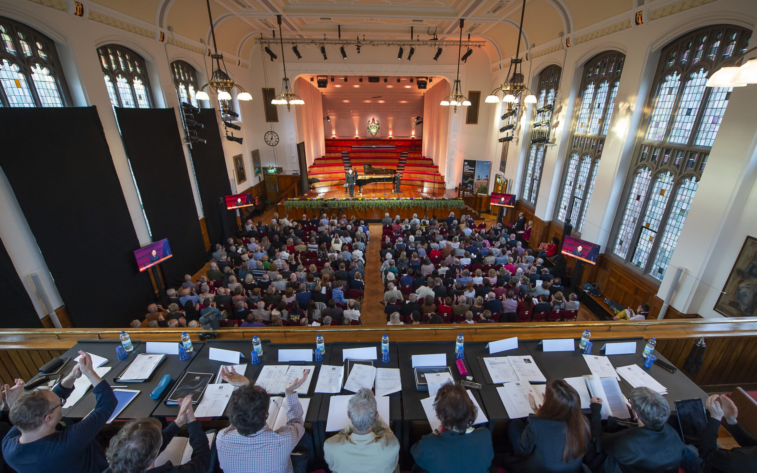 Picture looking down into the great hall, showing judges, audience and grand piano on stage.